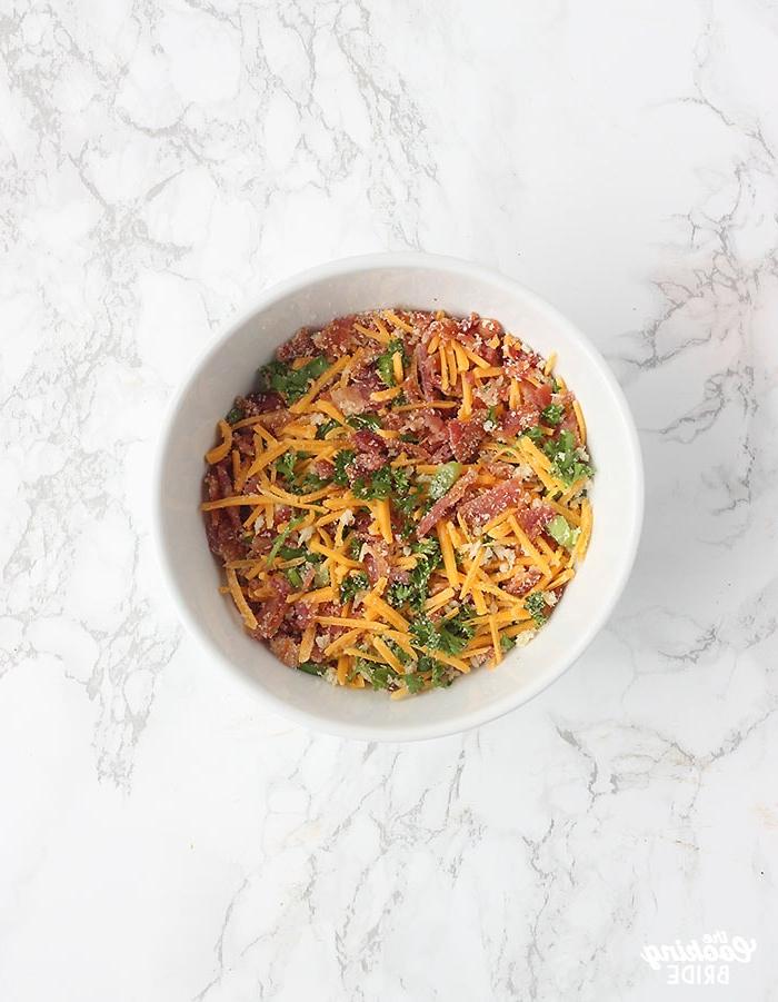bacon cheddar topping for the eggs on a small white bowl.