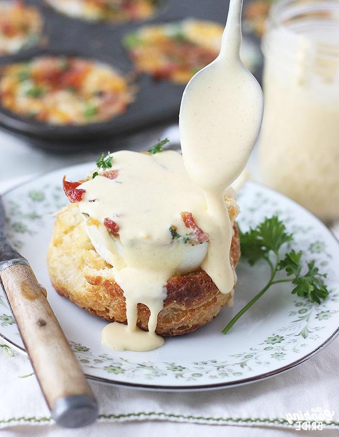 drizzling hollandaise sauce over an egg