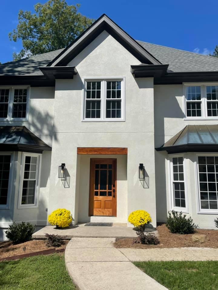 new exterior stained front door of stucco remodeled home